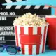 Buckets of popcorn with a movie real and "cut" board