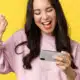 Woman celebrating a win while playing mobile game