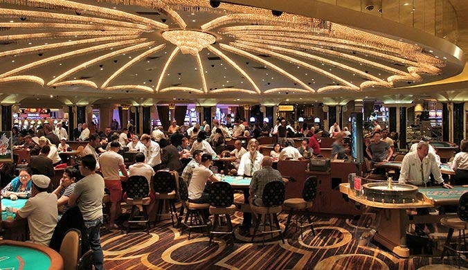Beat the System! A busy land casino floor with people playing at all the tables