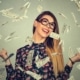 attractive young woman ecstatic over receiving a Red Stag 100 free spins shown by money cascading down all around her