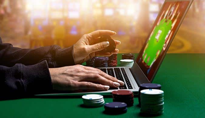 woman playing South African Online Gambling on a laptop