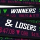 An image of black digital stock market share price indicators with the words ‘winners’ and & 'losers’ in white