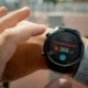 A photo of a person wearing a smart watch showing calories burned on a blurred background