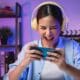 young woman playing an online game on her phone with a headset on